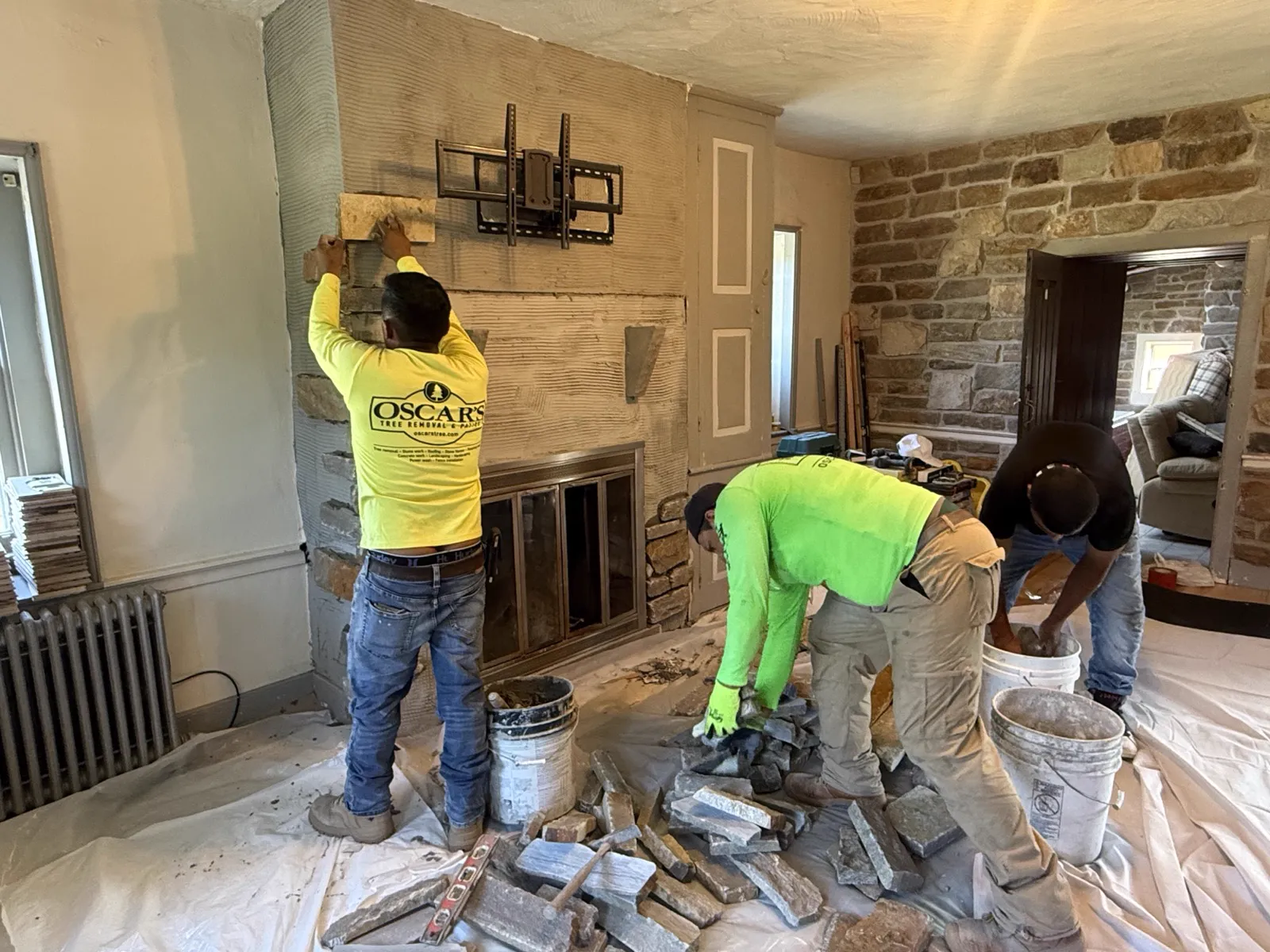 Stone veneer fireplace surround being built by Oscar's crew in a Bucks County home
